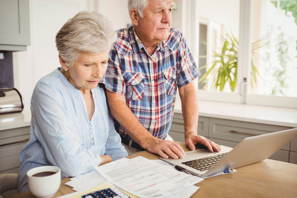 Senior couple checking their bills